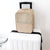 Portable waterproof shoe bag in khaki color on top of a white suitcase, ideal for travel organization.