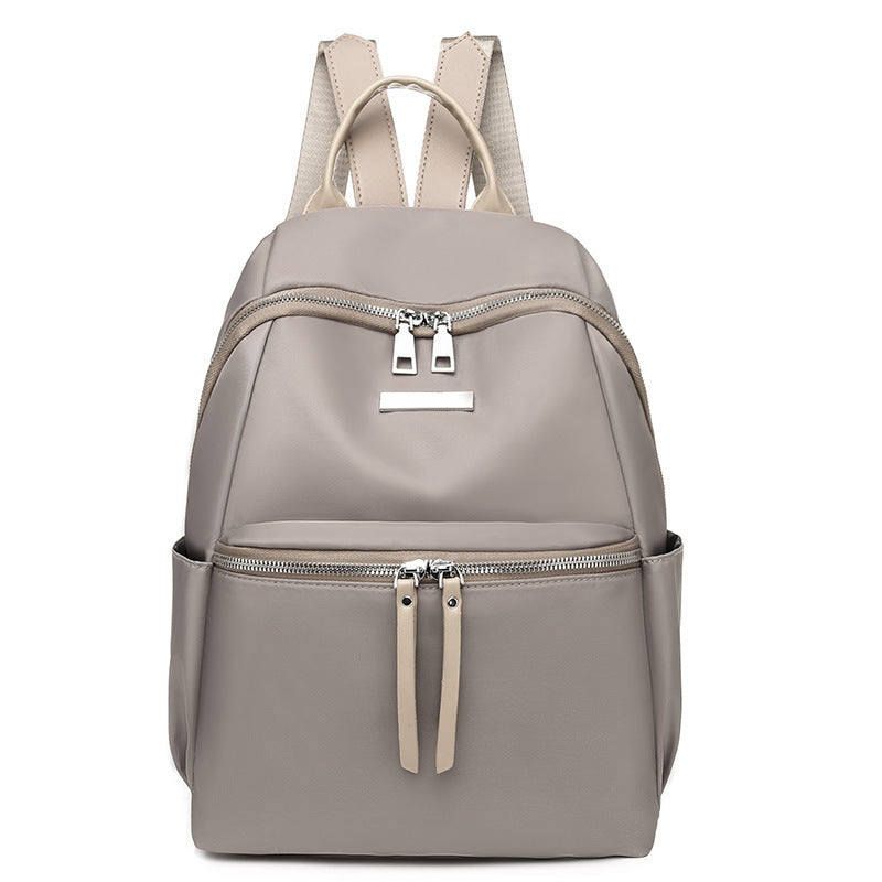 Women's custom backpack in gray with dual zippers and an elegant design, made from durable nylon fabric.