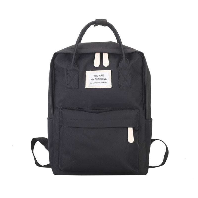 Stylish black backpack with "You Are My Sunshine" label, featuring durable canvas material and multiple compartments.
