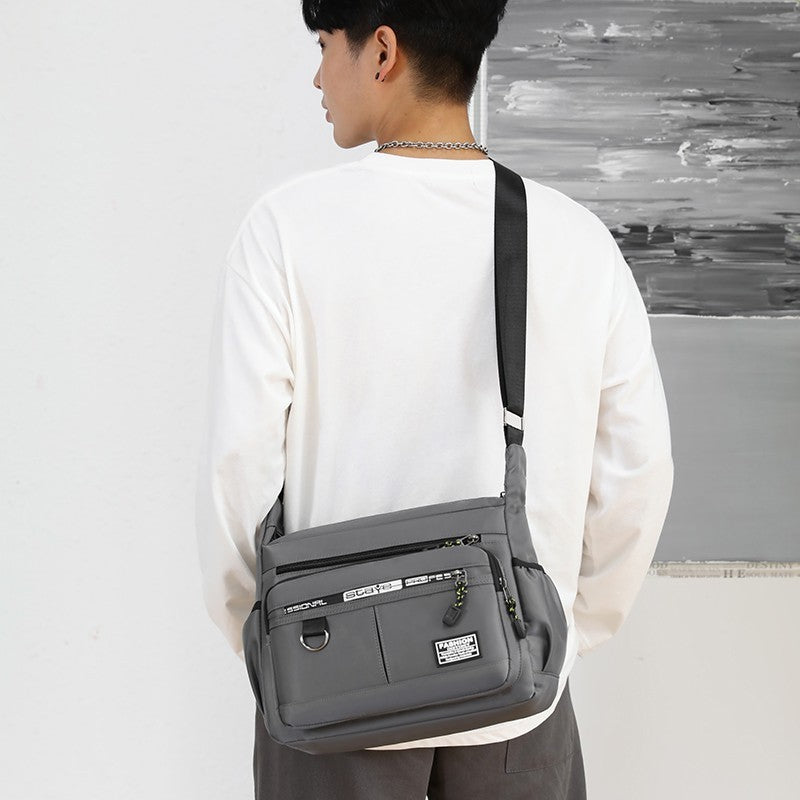 Men's crossbody bag in gray, featuring multi-pocket design, urban style, perfect for daily use.