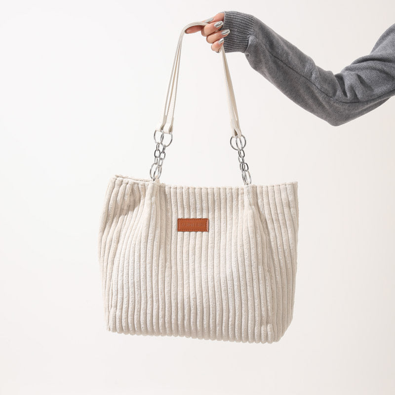 Creamy-white corduroy tote bag for women with double straps, ideal for autumn and winter daily outfits.